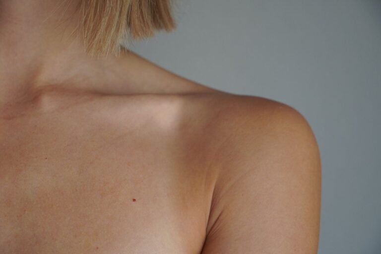 Soft natural light on the bare shoulder and skin of a person