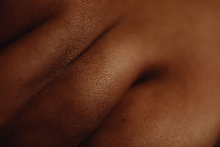 Soft natural-light close-up of deep-toned skin texture