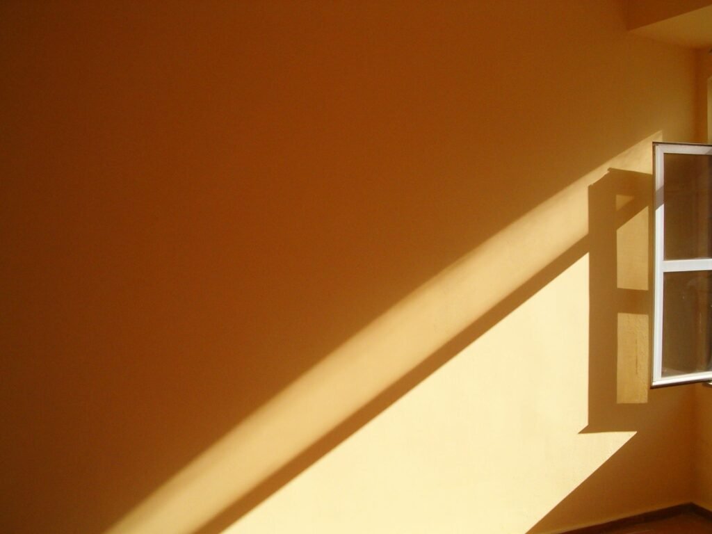 Sunlight streaming through an open window into a room