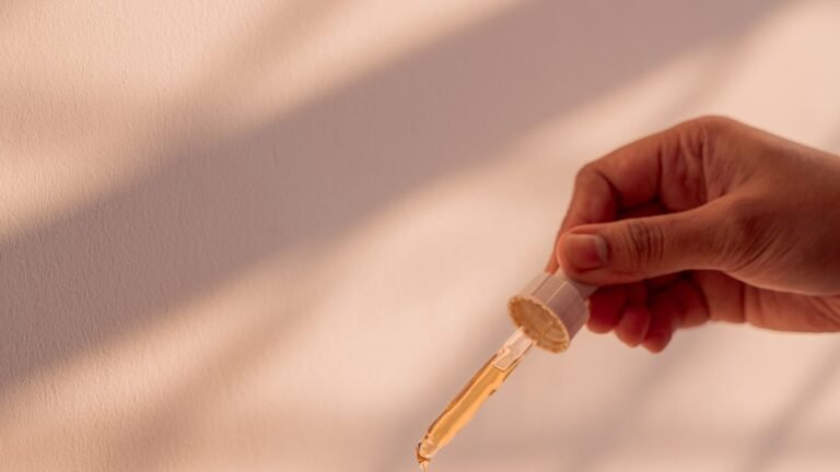 Serum being dispensed from a glass dropper bottle